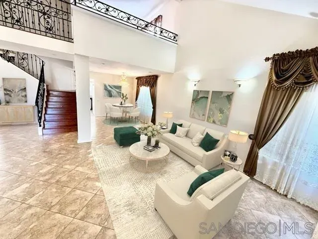 a view of a livingroom with furniture and staircase