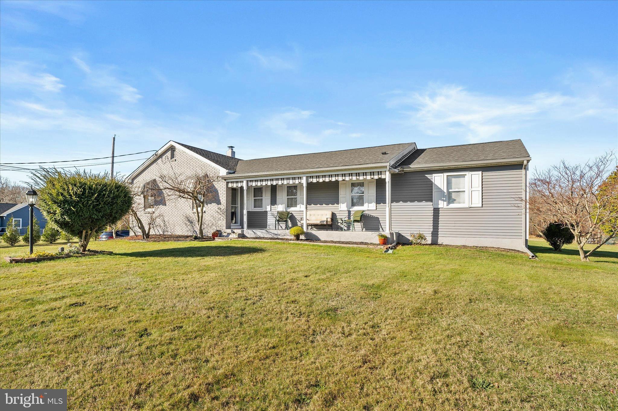 151 Walnford Road Allentown, NJ 08501 - Photo 1 of 49 a backyard of a house with table and chairs and potted plants