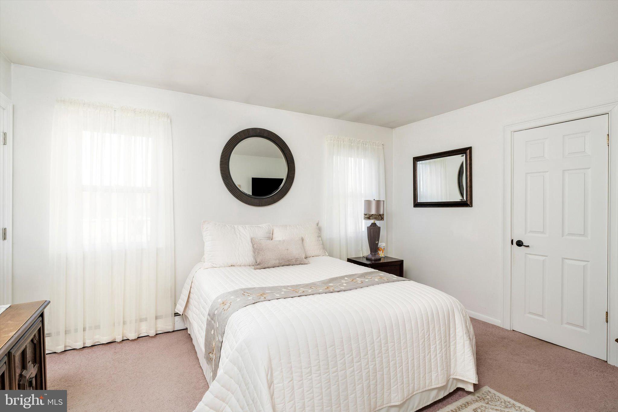 151 Walnford Road Allentown, NJ 08501 - Photo 14 of 49 a bedroom with a bed and a lamp on the dresser