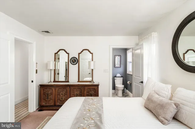 a living room with furniture and a mirror