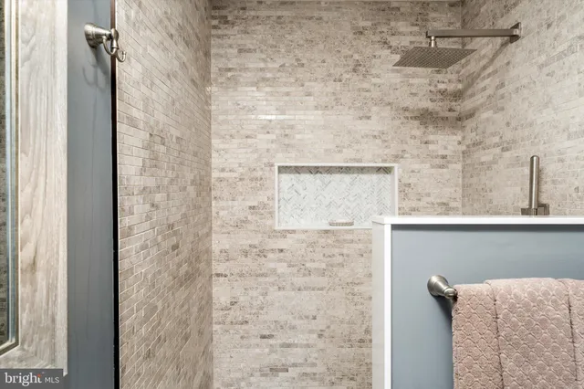 a bathroom with a shower and a window