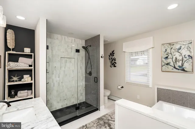 a bathroom with a shower a sink and a bathtub