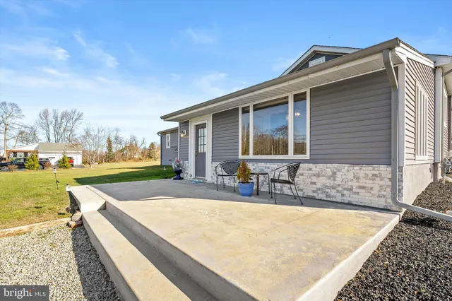 a view of a house with swimming pool and sitting area