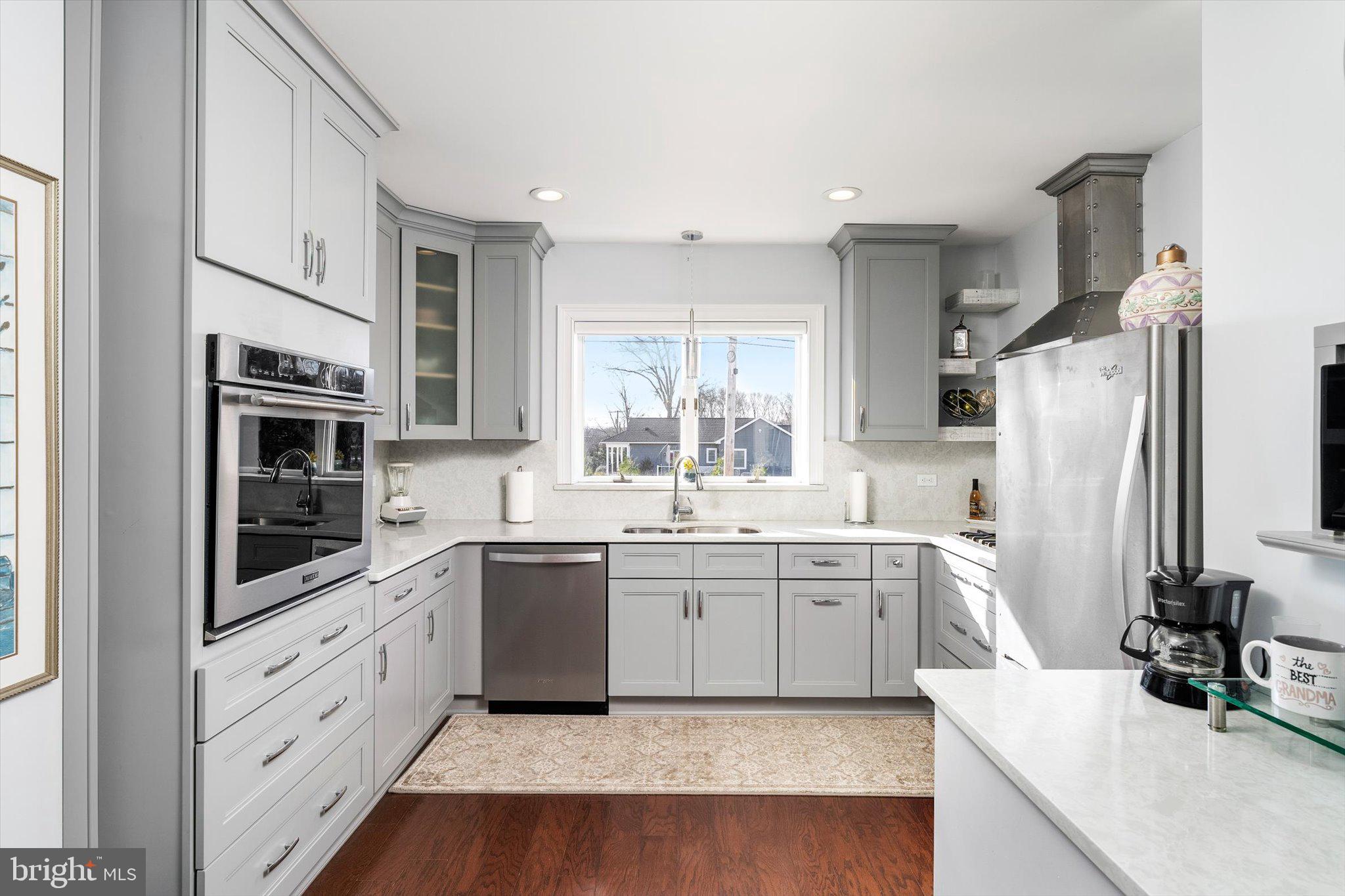 151 Walnford Road Allentown, NJ 08501 - Photo 6 of 49 a large kitchen with a sink dishwasher stove and white cabinets with wooden floor