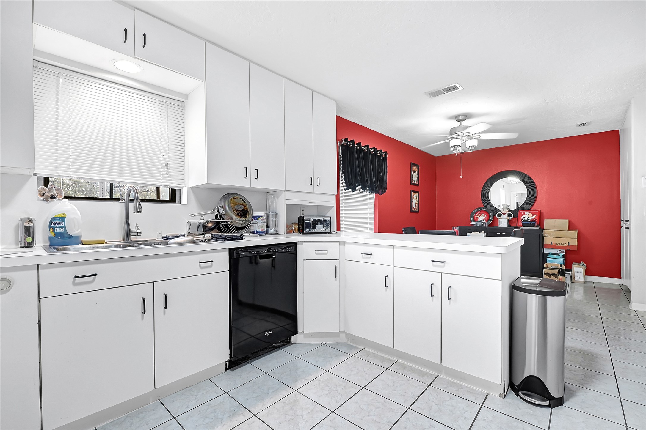 4831 Knickerbocker Street Houston, TX 77035 - Photo 3 of 50 Kitchen view featuring bold accent wall, white cabinetry, and open layout.