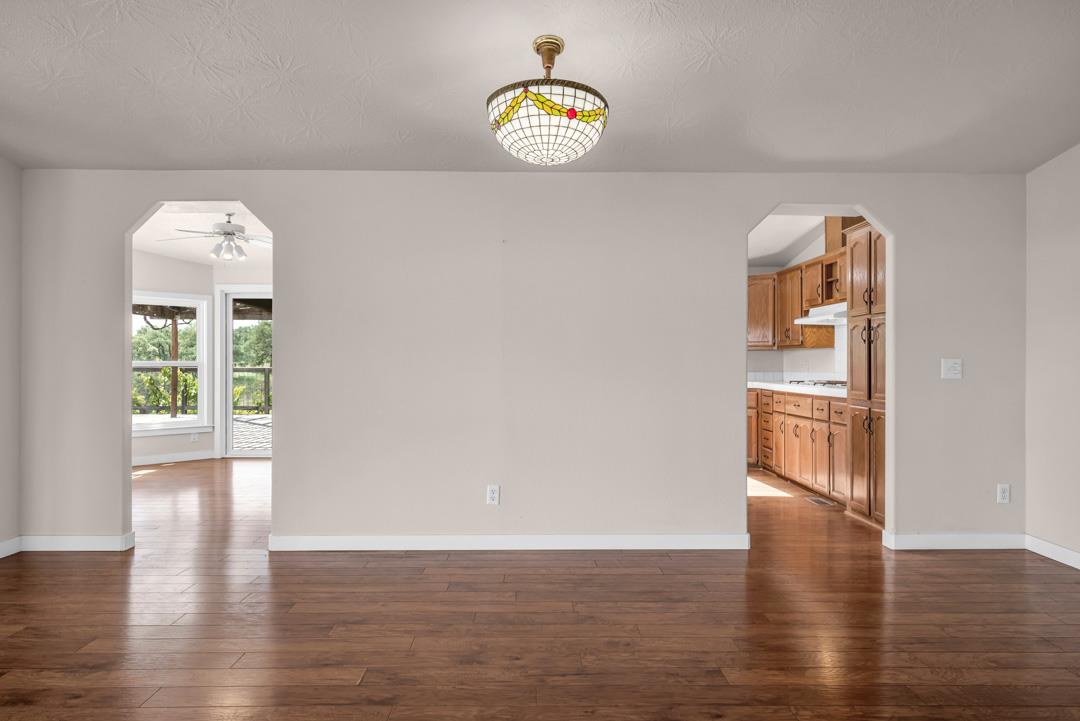 10721 Shenandoah Road Plymouth, CA 95669 - Photo 13 of 48 a view of an empty room with wooden floor and a window