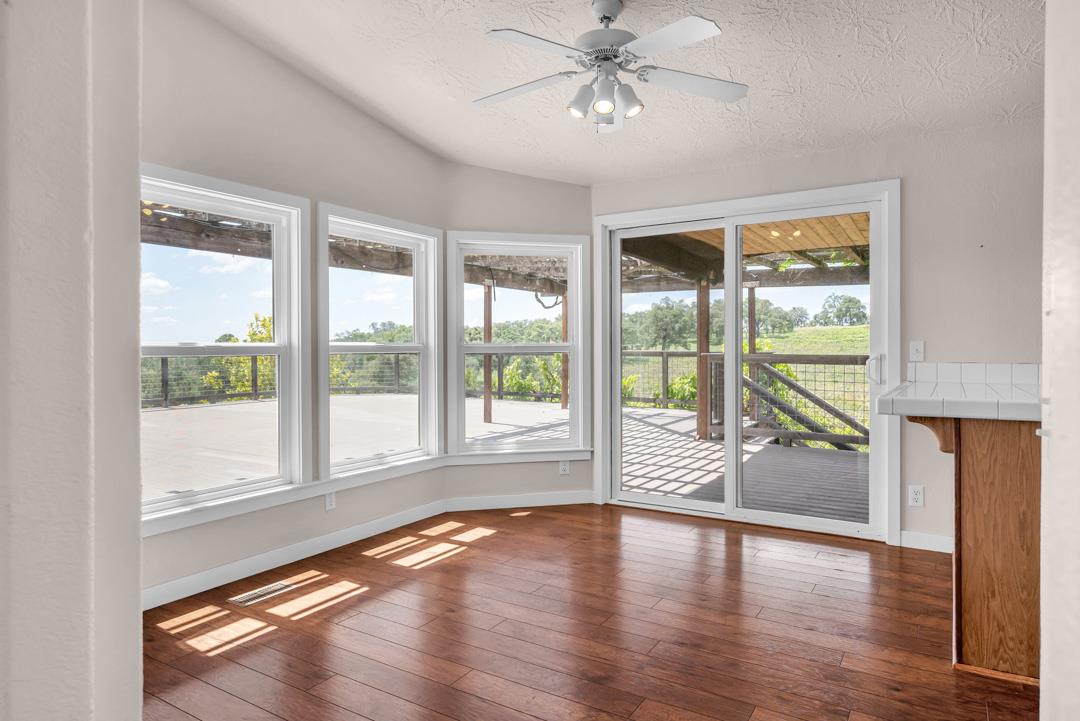 10721 Shenandoah Road Plymouth, CA 95669 - Photo 17 of 48 a view of empty room with wooden floor and fan
