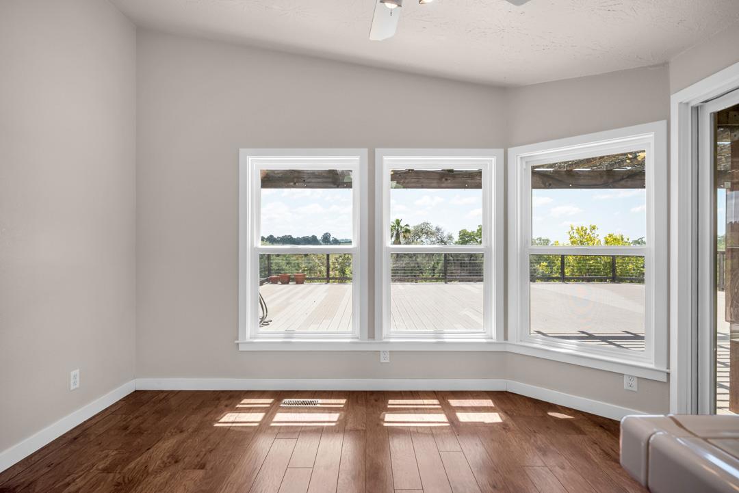 10721 Shenandoah Road Plymouth, CA 95669 - Photo 18 of 48 a view of empty room with wooden floor and fan