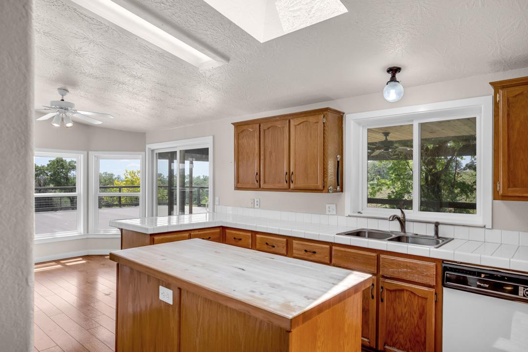 10721 Shenandoah Road Plymouth, CA 95669 - Photo 20 of 48 a kitchen that has a sink and a wooden floor