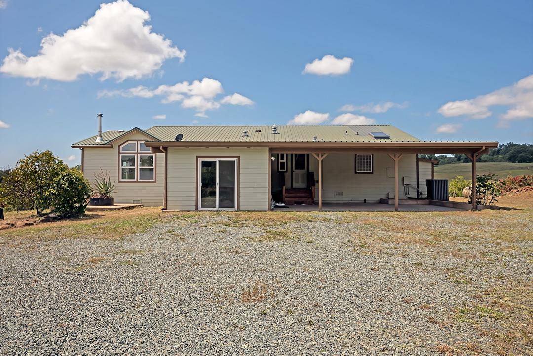 10721 Shenandoah Road Plymouth, CA 95669 - Photo 2 of 48 a front view of a house with a yard and garage