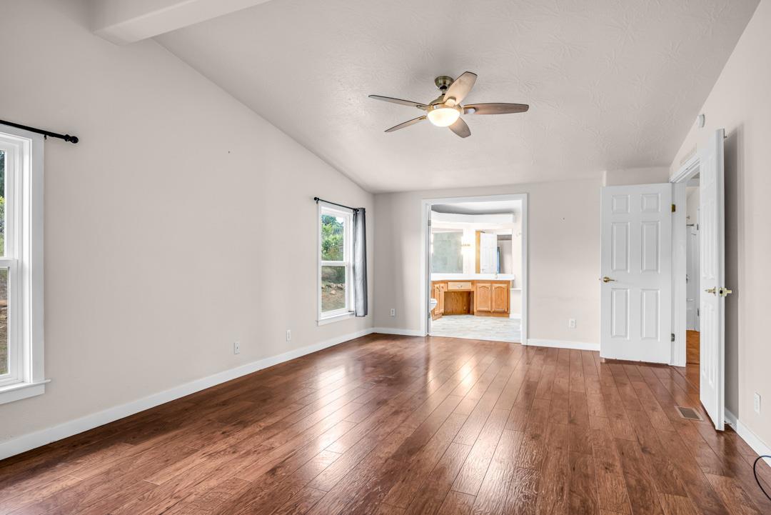 10721 Shenandoah Road Plymouth, CA 95669 - Photo 29 of 48 a view of an empty room with wooden floor and a window