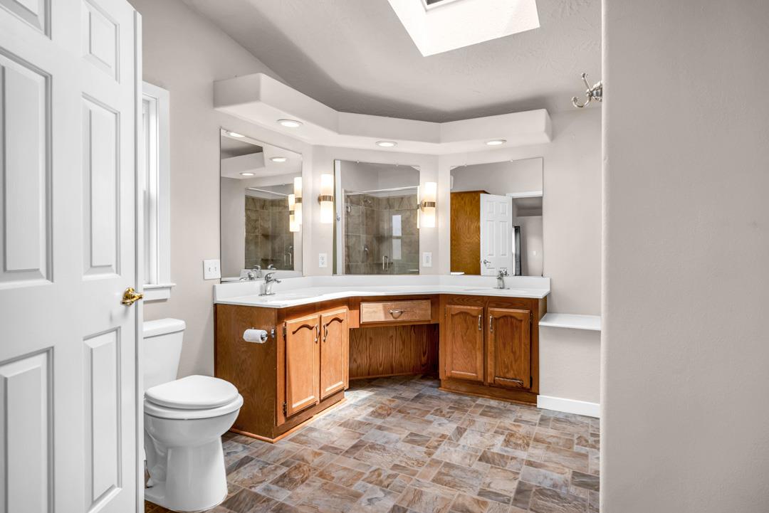 10721 Shenandoah Road Plymouth, CA 95669 - Photo 32 of 48 a bathroom with a granite countertop sink and a large mirror