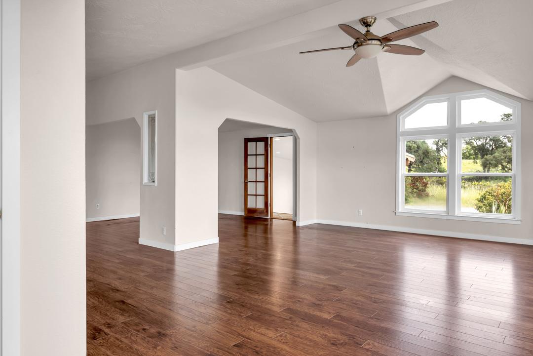 10721 Shenandoah Road Plymouth, CA 95669 - Photo 7 of 48 a view of an empty room with wooden floor and a window