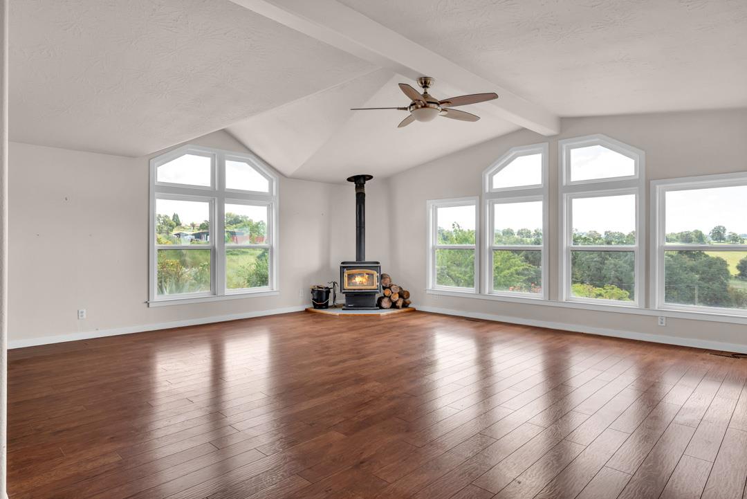 10721 Shenandoah Road Plymouth, CA 95669 - Photo 8 of 48 a view of a livingroom with wooden floor fan and a large window