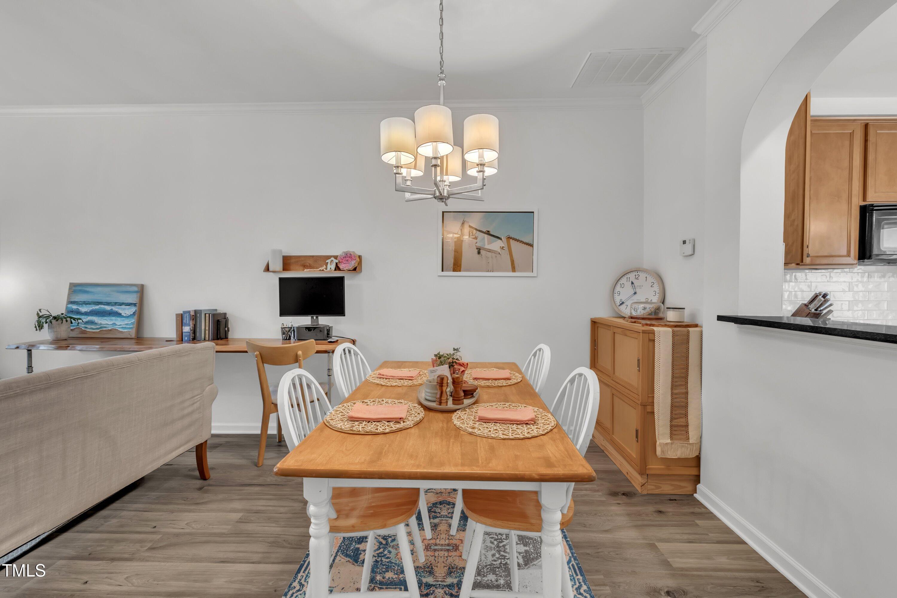 3583 Sugar Tree Place Durham, NC 27713 - Photo 12 of 50 a view of a dining room with furniture and wooden floor