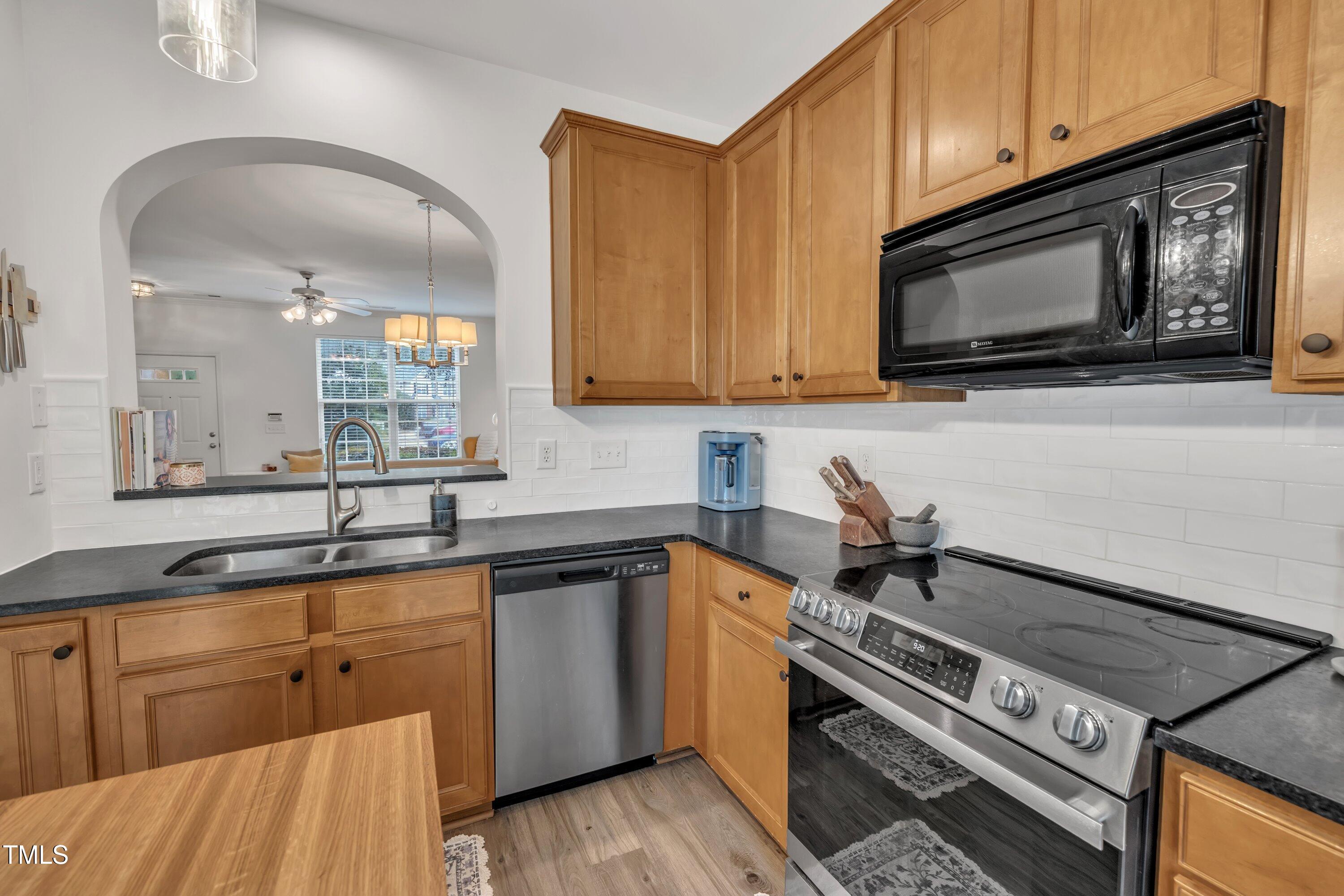 3583 Sugar Tree Place Durham, NC 27713 - Photo 16 of 50 a kitchen with a sink stove and microwave