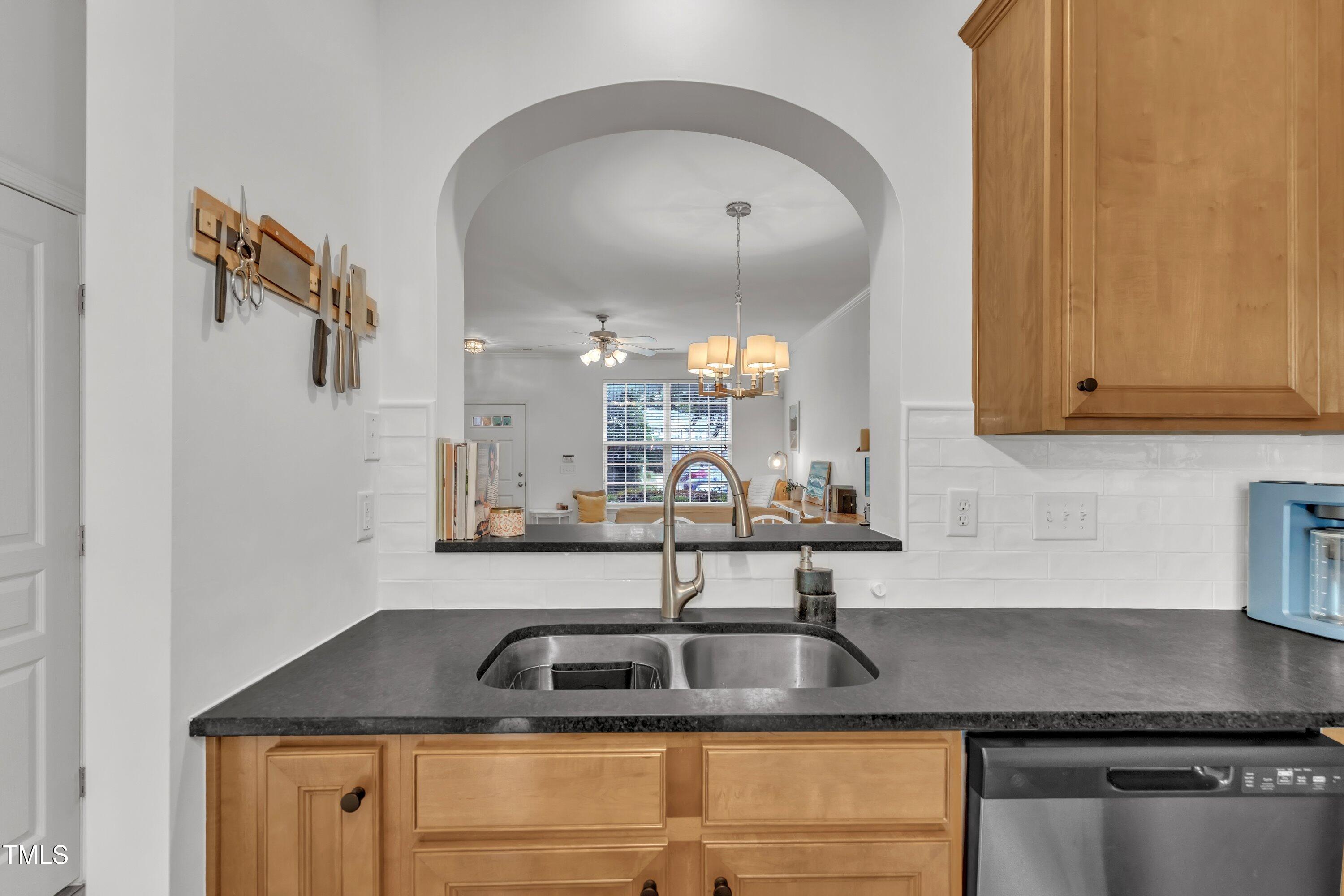 3583 Sugar Tree Place Durham, NC 27713 - Photo 19 of 50 a kitchen with sink a mirror and cabinets