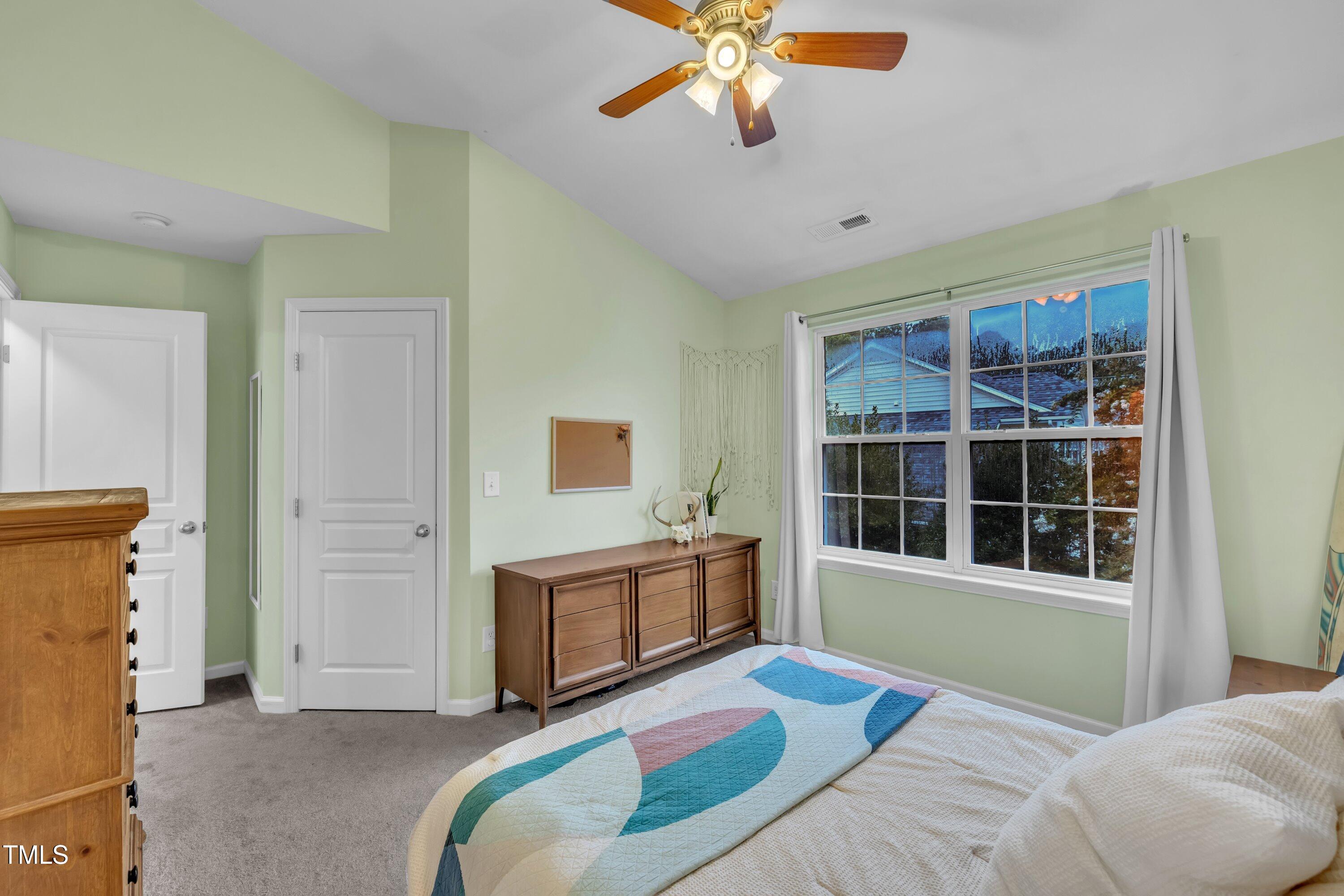 3583 Sugar Tree Place Durham, NC 27713 - Photo 24 of 50 a bedroom with a bed and a chandelier