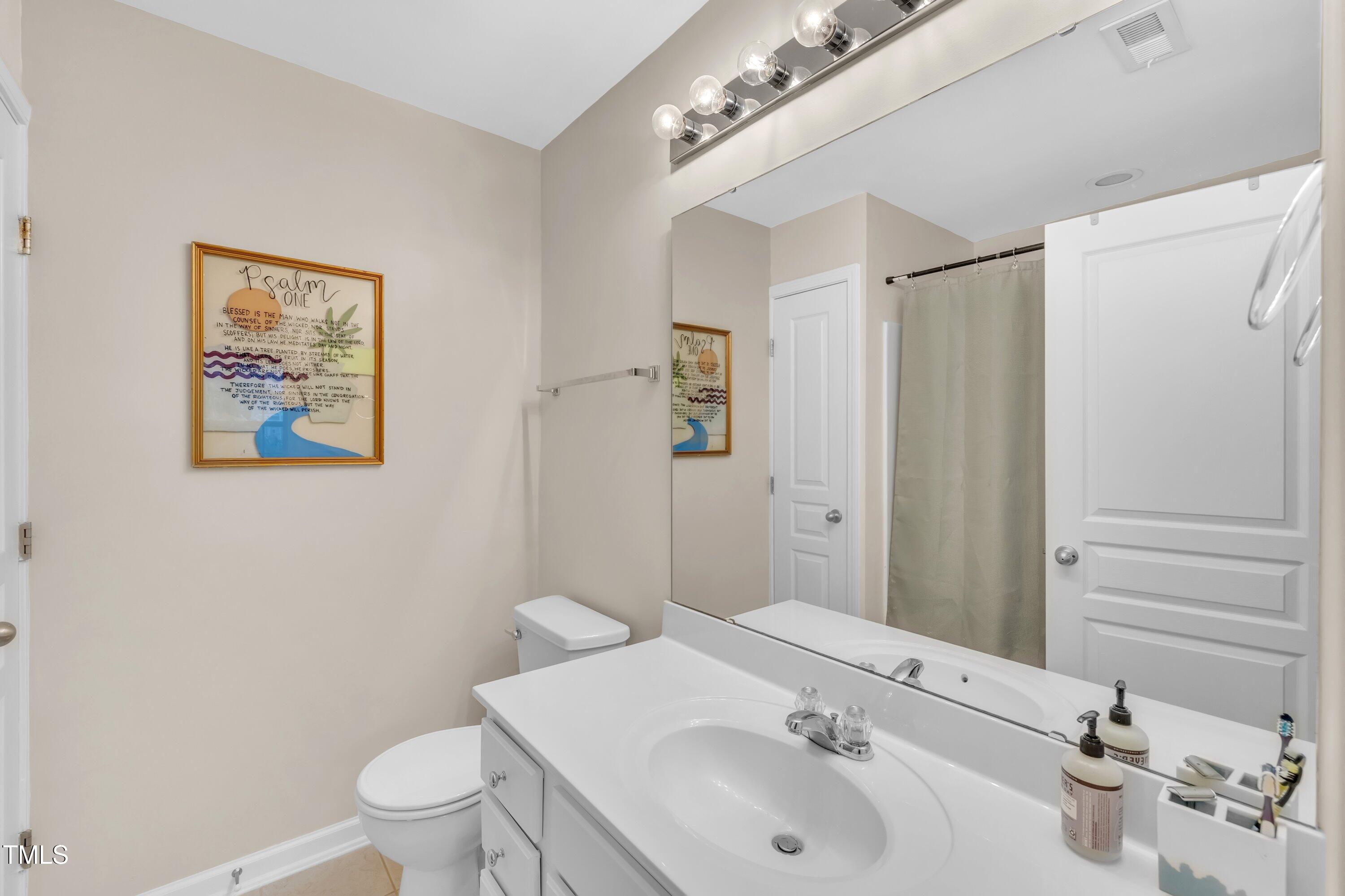3583 Sugar Tree Place Durham, NC 27713 - Photo 25 of 50 a bathroom with a sink and mirror with toilet