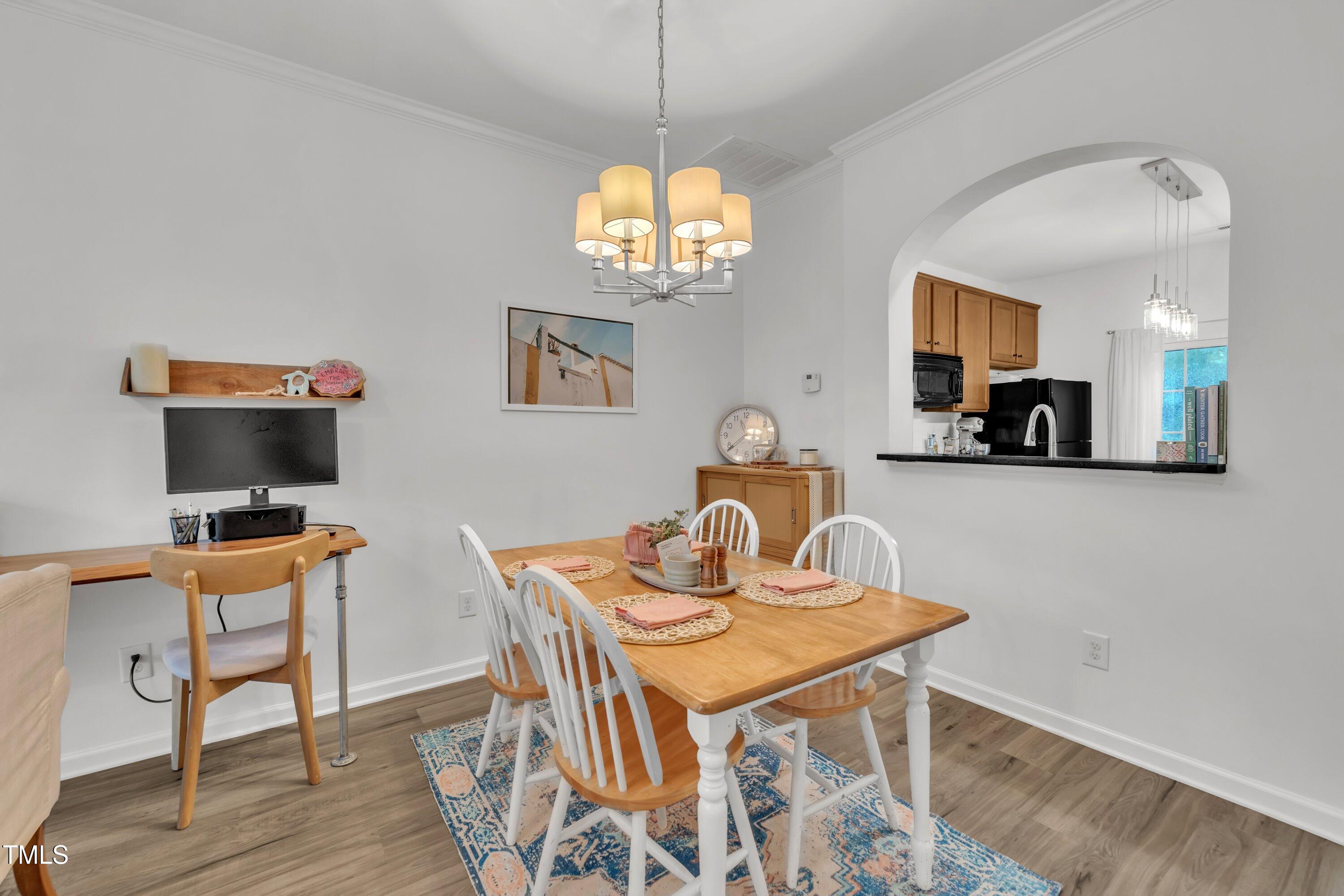 3583 Sugar Tree Place Durham, NC 27713 - Photo 8 of 50 a view of a dining room with furniture a chandelier and wooden floor