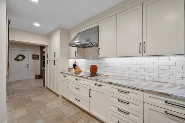 a large kitchen with a table and chairs in it