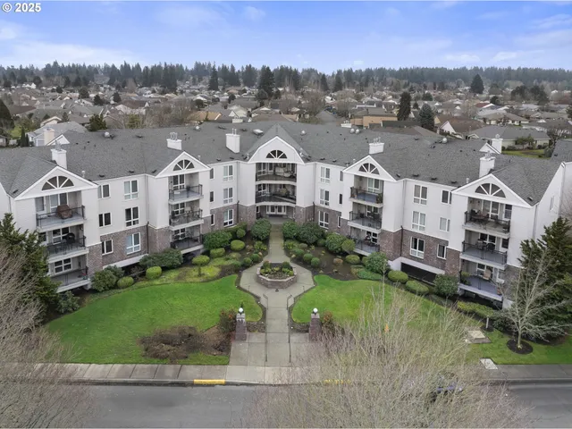 an aerial view of residential houses with outdoor space and trees