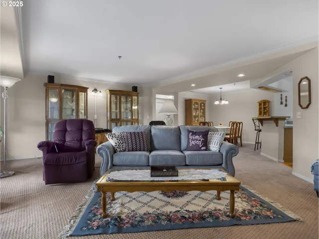 a kitchen with granite countertop a sink cabinets stainless steel appliances and wooden floor