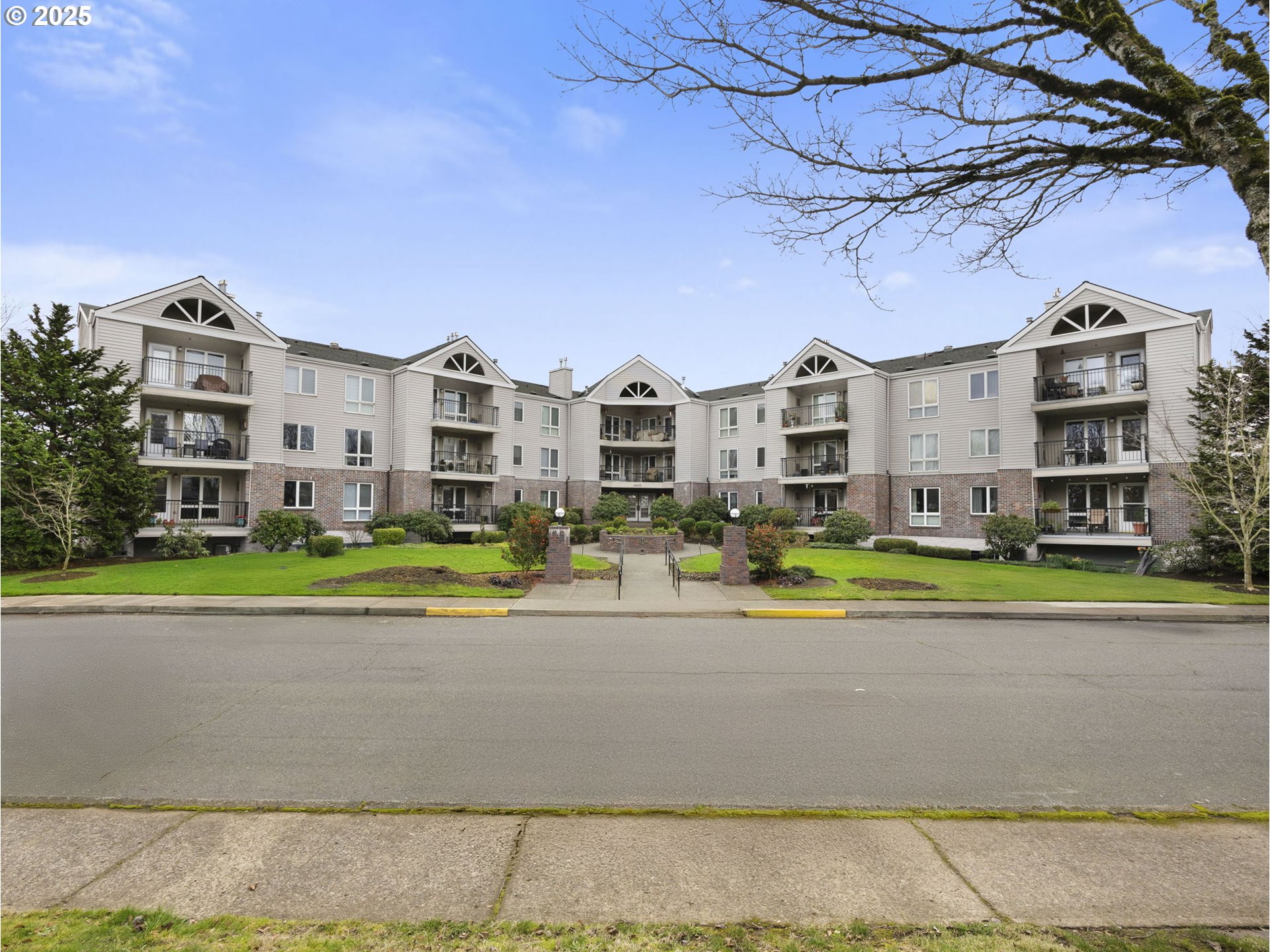 15530 Northeast Knott Street, Unit 32 Portland, OR 97230 - Photo 2 of 48 a front view of a house with a yard and trees