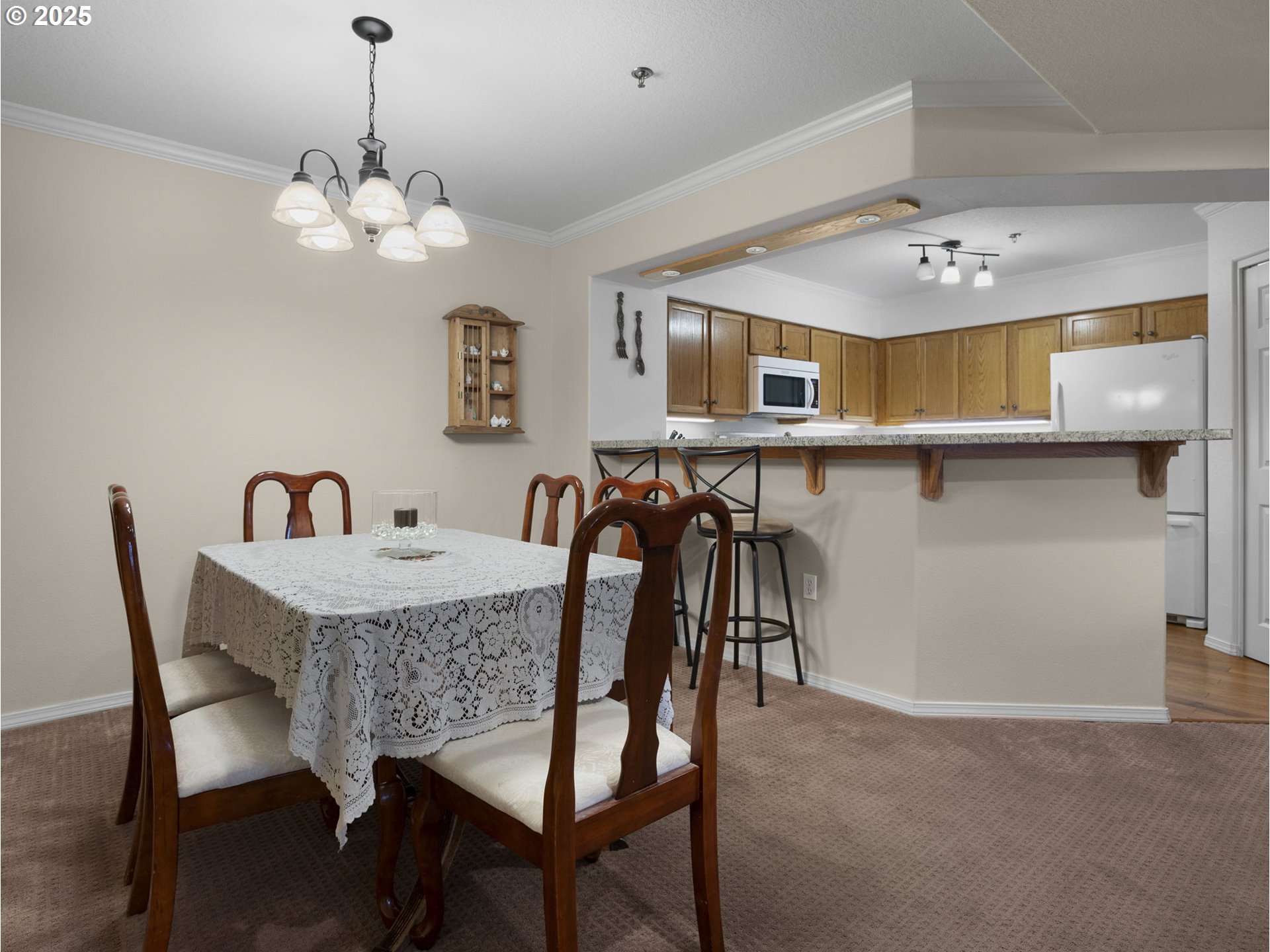 15530 Northeast Knott Street, Unit 32 Portland, OR 97230 - Photo 22 of 48 a view of a dining room with furniture and chandelier