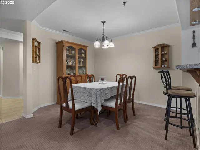 a view of a hallway with a refrigerator and a sink