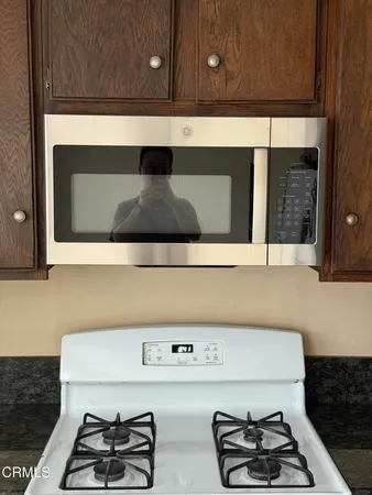 a kitchen with a stove and a microwave
