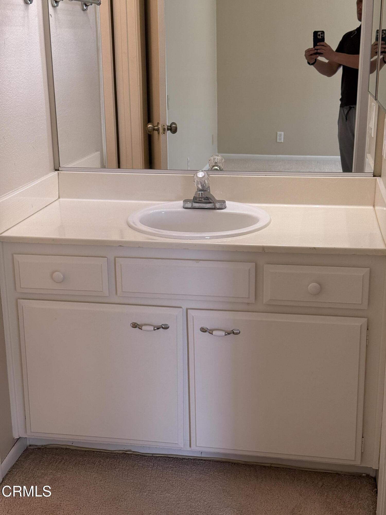 5209 Perkins Road Oxnard, CA 93033 - Photo 20 of 28 a bathroom with a sink and a mirror