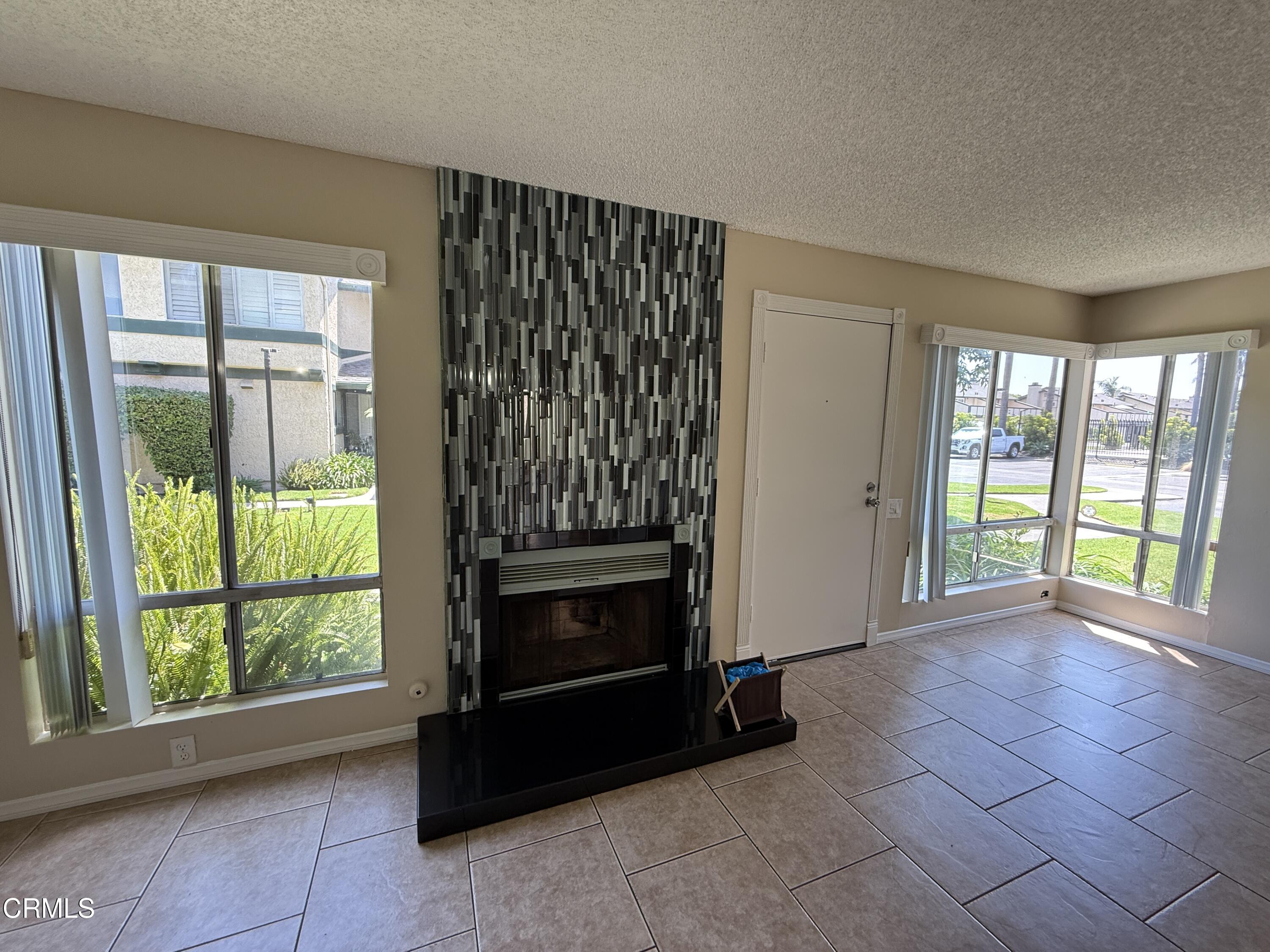 5209 Perkins Road Oxnard, CA 93033 - Photo 5 of 28 a view of an empty room with a fireplace and a window