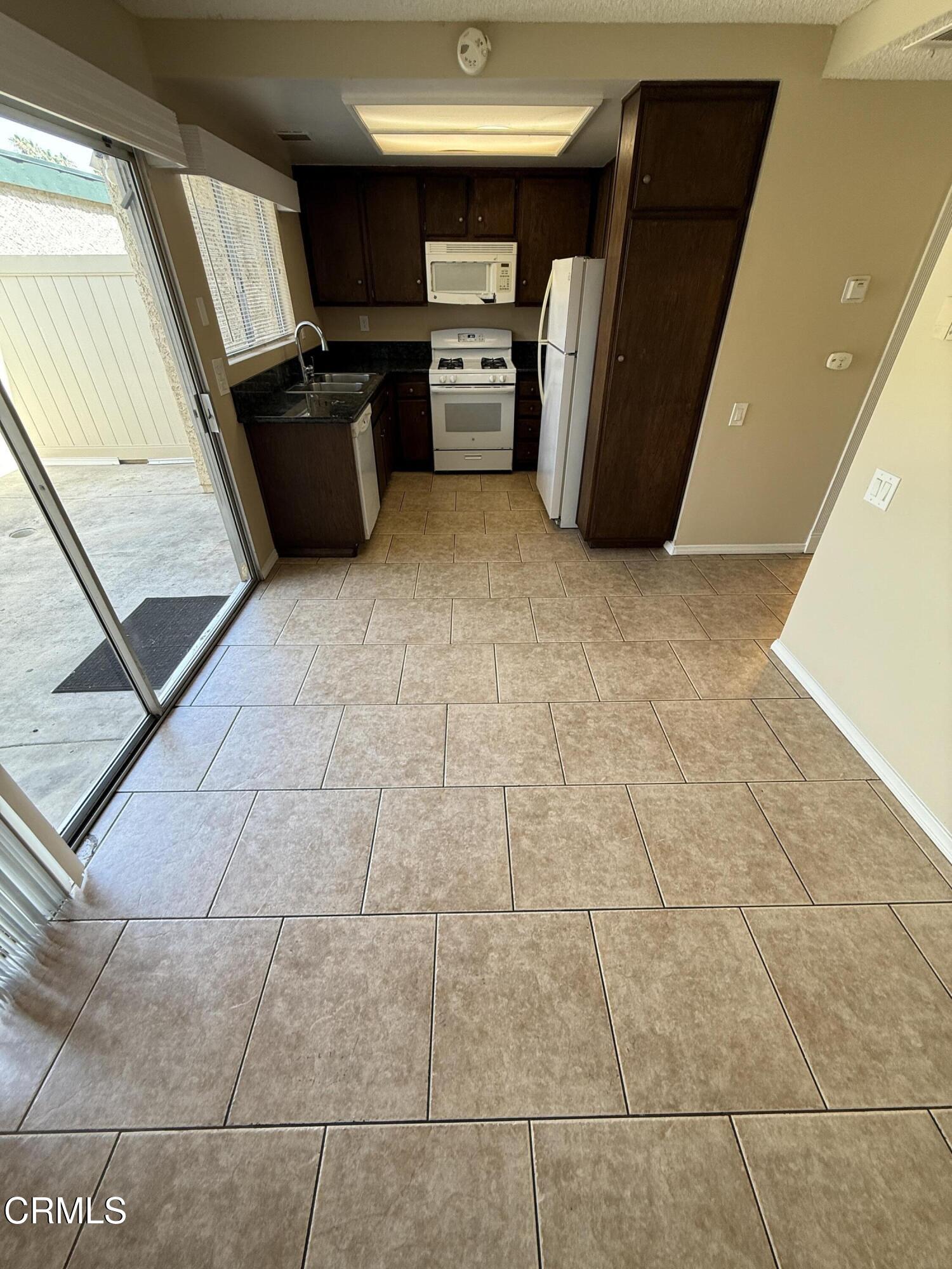 5209 Perkins Road Oxnard, CA 93033 - Photo 9 of 28 a view of a refrigerator in kitchen and a sink