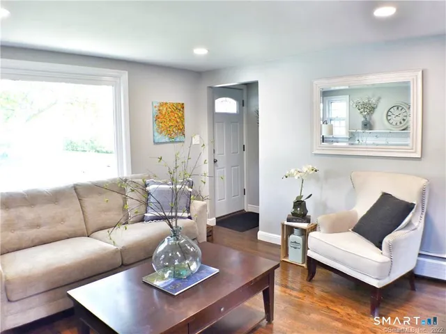 a living room with furniture a rug and a window
