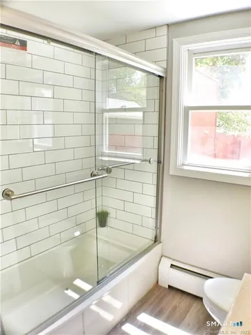 a bathroom with a shower and a bathtub