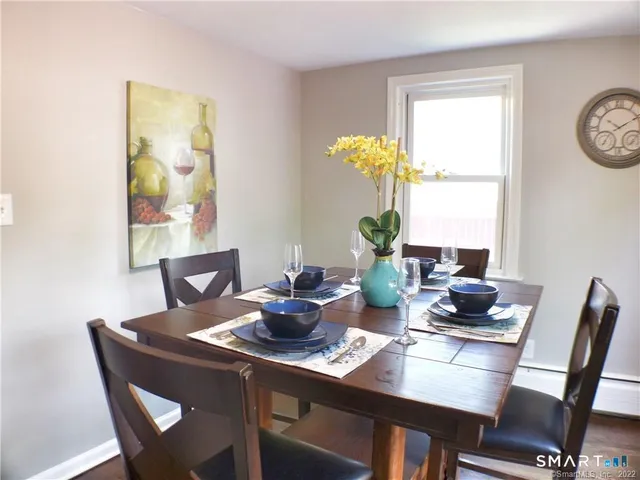 a dining room with furniture and wooden floor