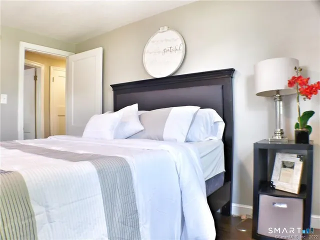 a bedroom with a bed and a chandelier