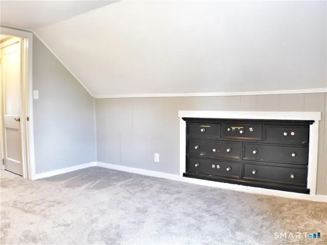 a room with a dresser and a mirror