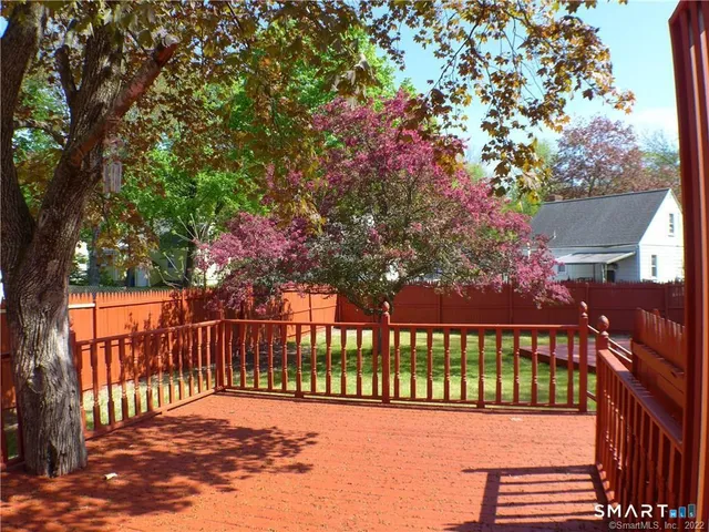 a view of a house with wooden deck