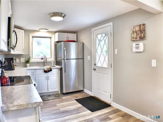 a kitchen with a refrigerator and a sink