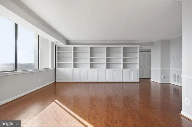 a kitchen with stainless steel appliances granite countertop a stove and white cabinets