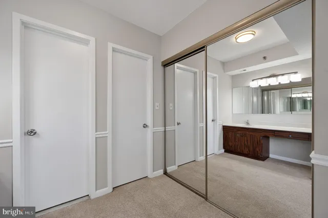 a bathroom with a glass door shower sink and mirror