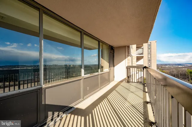 a living room with furniture a large window and a fireplace