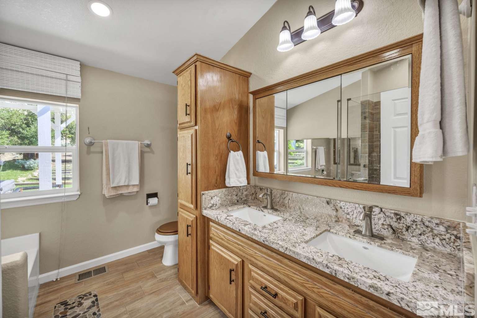 160-180 Quarter Horse Circle Reno, NV 89508 - Photo 11 of 23 a bathroom with a granite countertop sink and a mirror