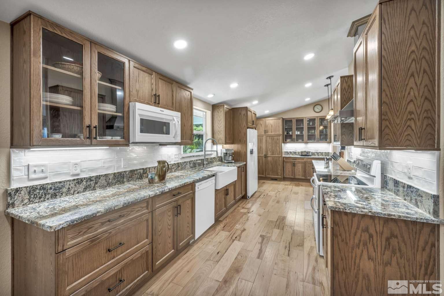160-180 Quarter Horse Circle Reno, NV 89508 - Photo 8 of 23 a large kitchen with stainless steel appliances granite countertop a lot of counter space and wooden floors