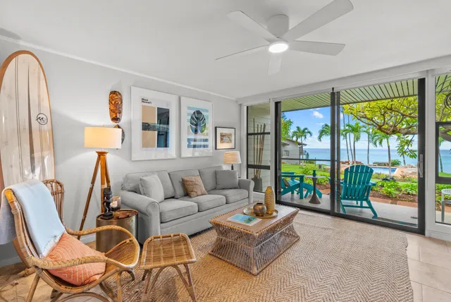 a living room with fireplace furniture and a floor to ceiling window