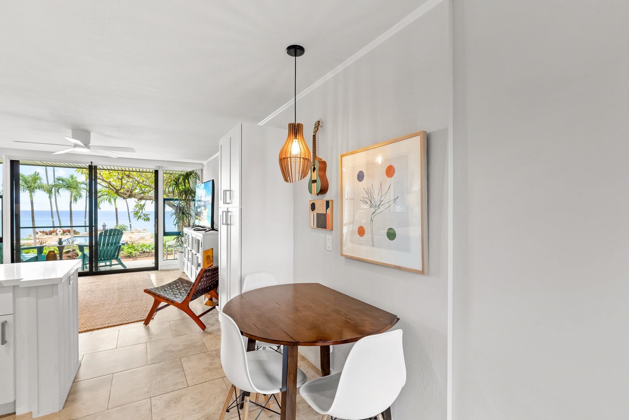 4057 Lower Honoapiilani Road, Unit 114 Lahaina, HI 96761 - Photo 14 of 23 a living room with furniture and a floor to ceiling window