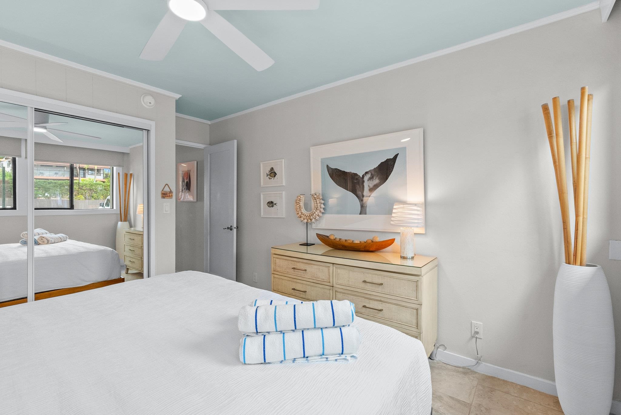 4057 Lower Honoapiilani Road, Unit 114 Lahaina, HI 96761 - Photo 16 of 23 a bedroom with a bed and a dresser in it