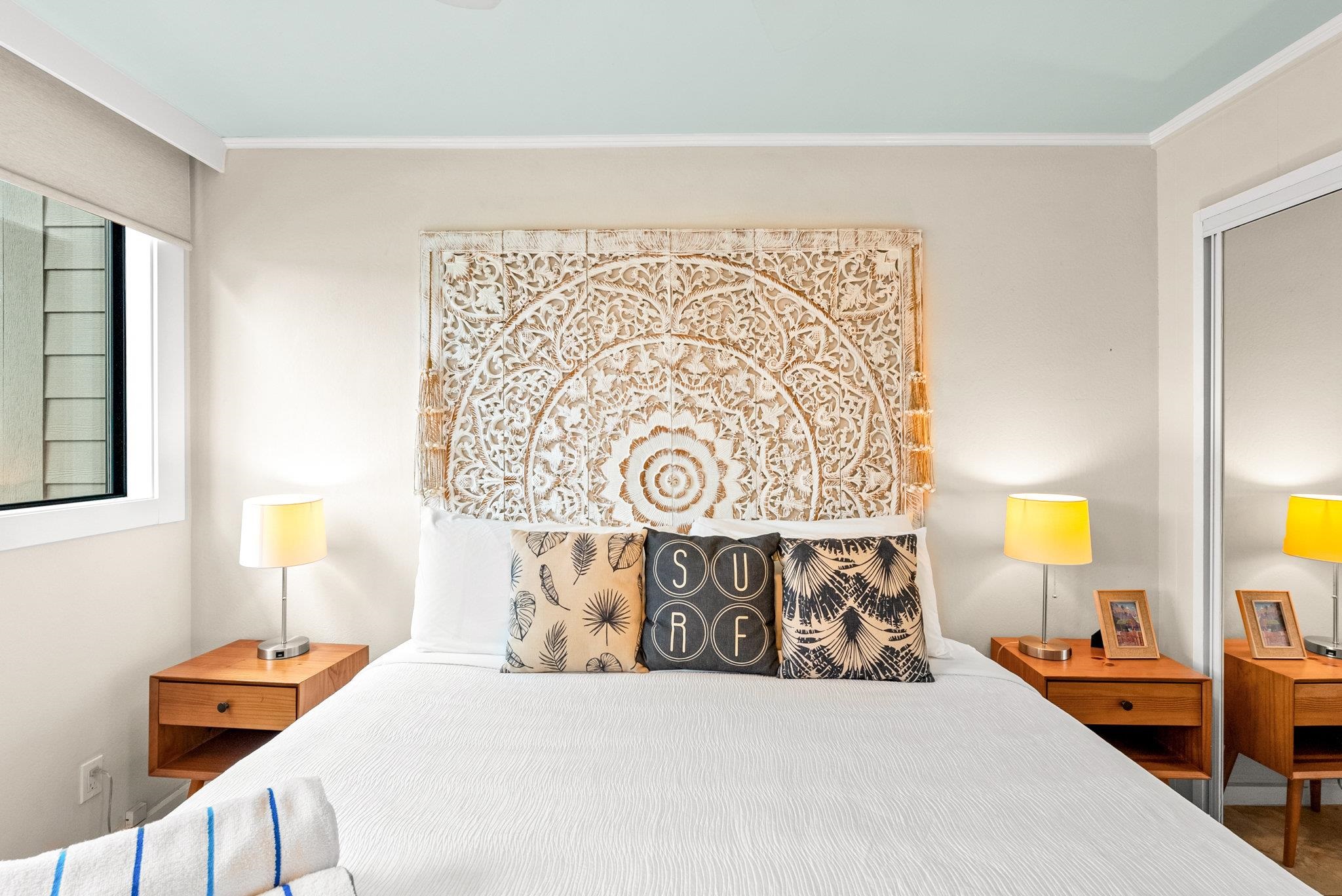 4057 Lower Honoapiilani Road, Unit 114 Lahaina, HI 96761 - Photo 17 of 23 a bed sitting in a bedroom next to a window